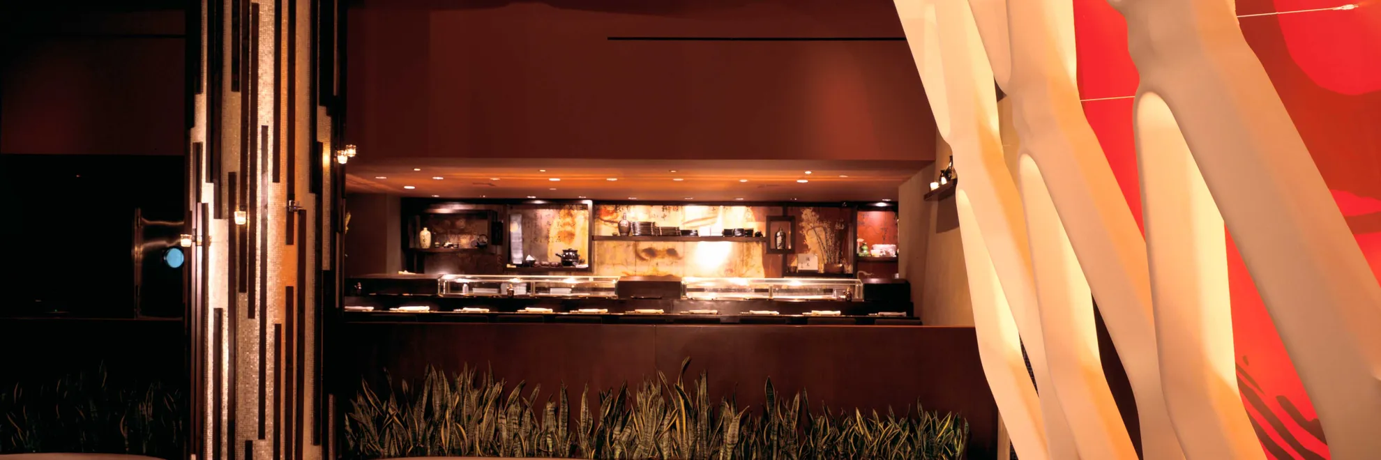 Koi restaurant main dining room with banquettes and open kitchen view