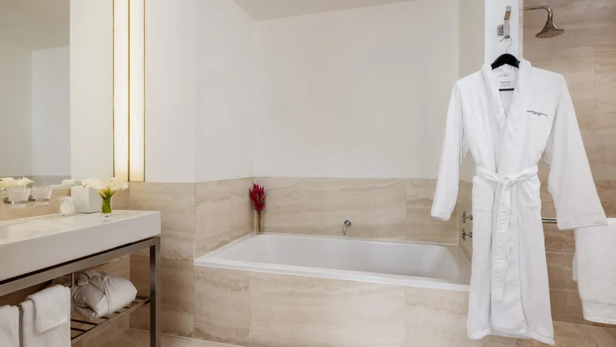 Junior Suite Park View bathroom with soaking tub and robe