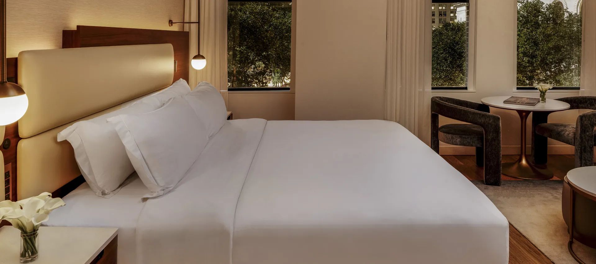 Bryant Park Suite bedroom at night with warm lighting