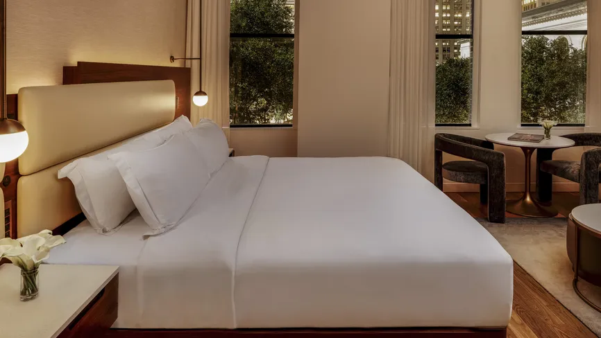 Bryant Park Suite bedroom at night with warm lighting