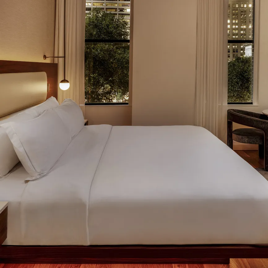 Bryant Park Suite bedroom at night with warm lighting