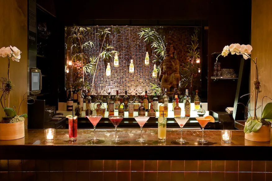 Koi restaurant main bar with colorful cocktails and backlit shelving