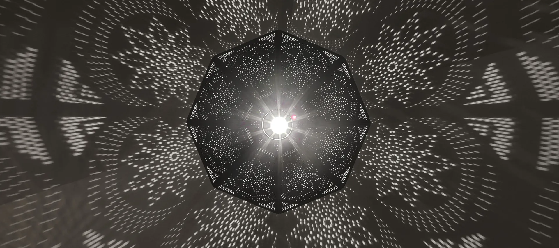 Decorative pendant light casting a starburst pattern at Célon Bar & Lounge