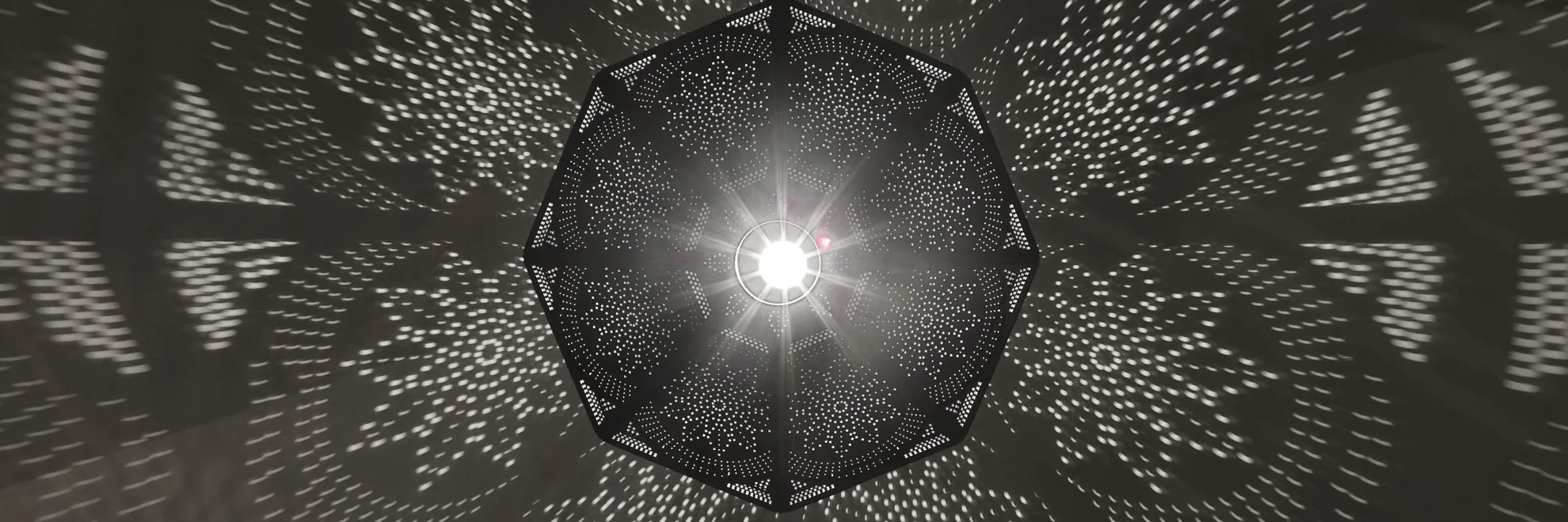 Decorative pendant light casting a starburst pattern at Célon Bar & Lounge