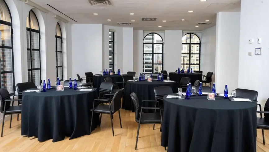 Conference Room set up boardroom-style with tall windows