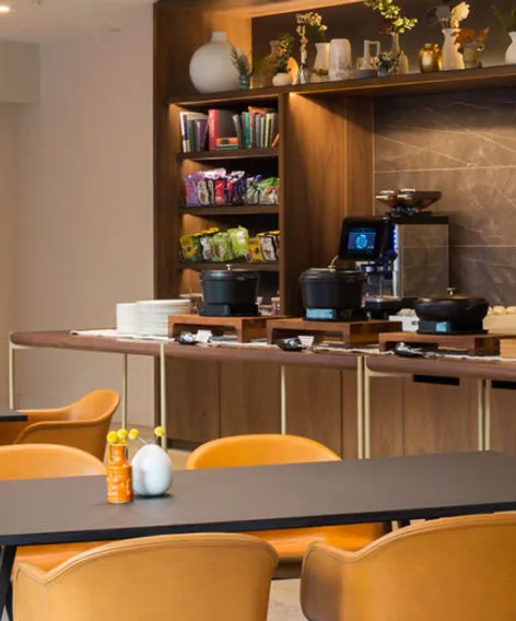 Restaurant interior with wood tables and pendant lighting