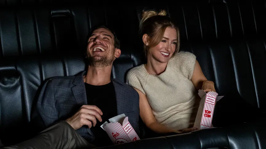 Couple laughing with popcorn in the Screening Room