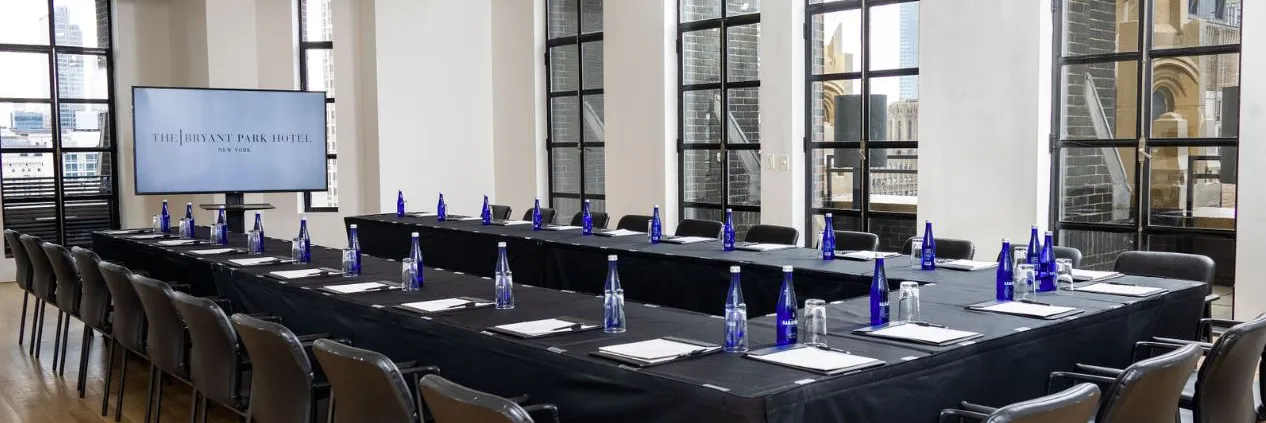 Conference Room set up boardroom-style with presentation screen