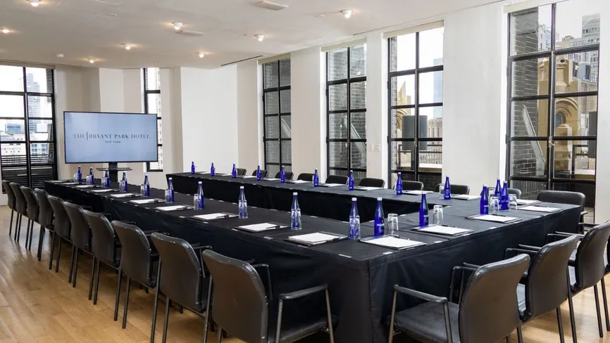 Conference Room set up boardroom-style with presentation screen