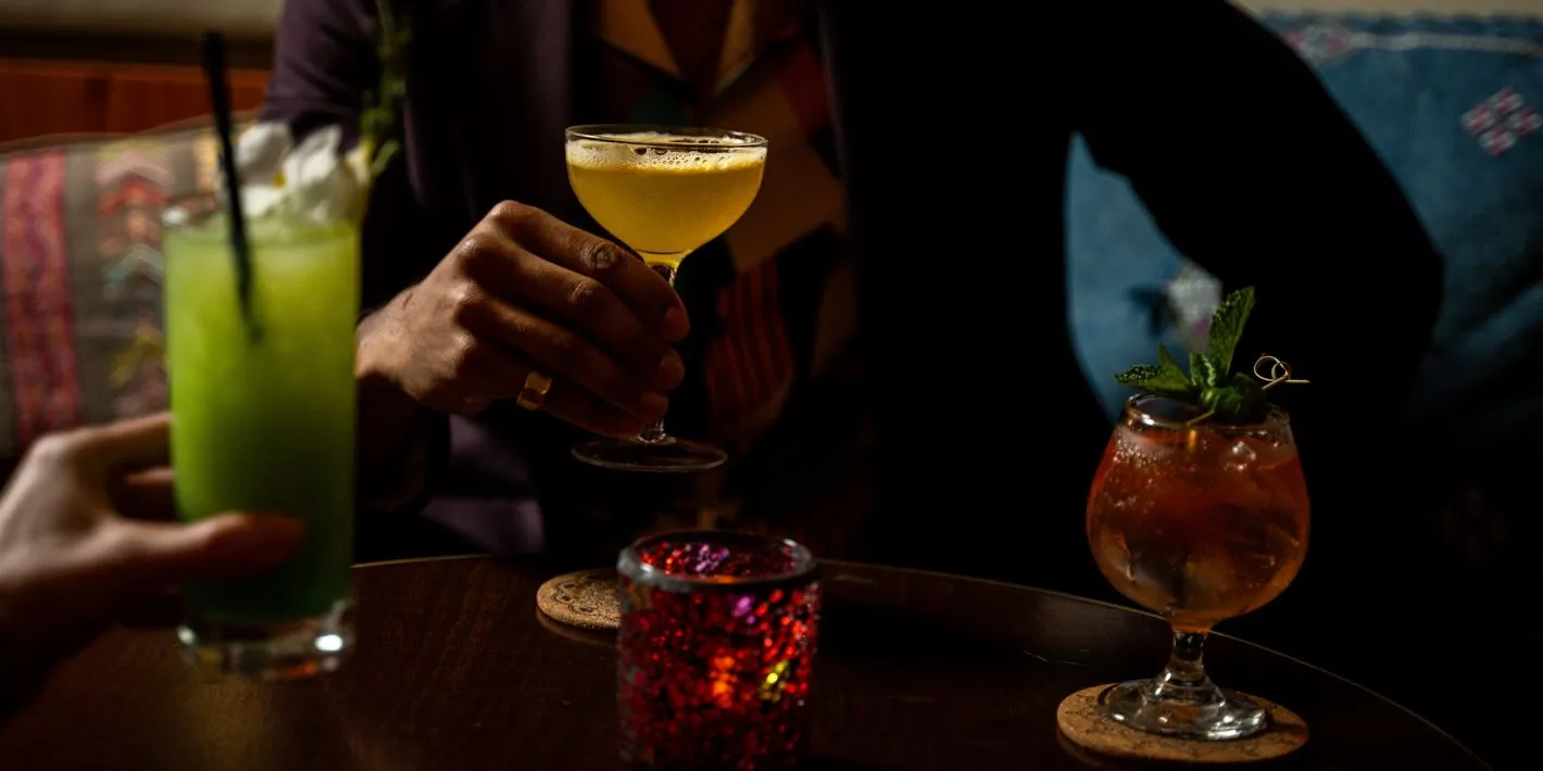 Assorted colorful cocktails on a dark table
