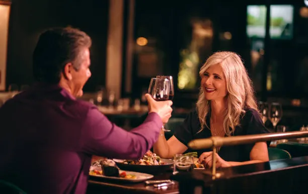 Senior couple toasting wine at a restaurant