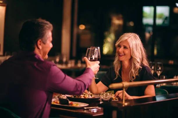 Senior couple toasting wine at a restaurant