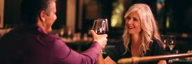 Senior couple toasting wine at a restaurant